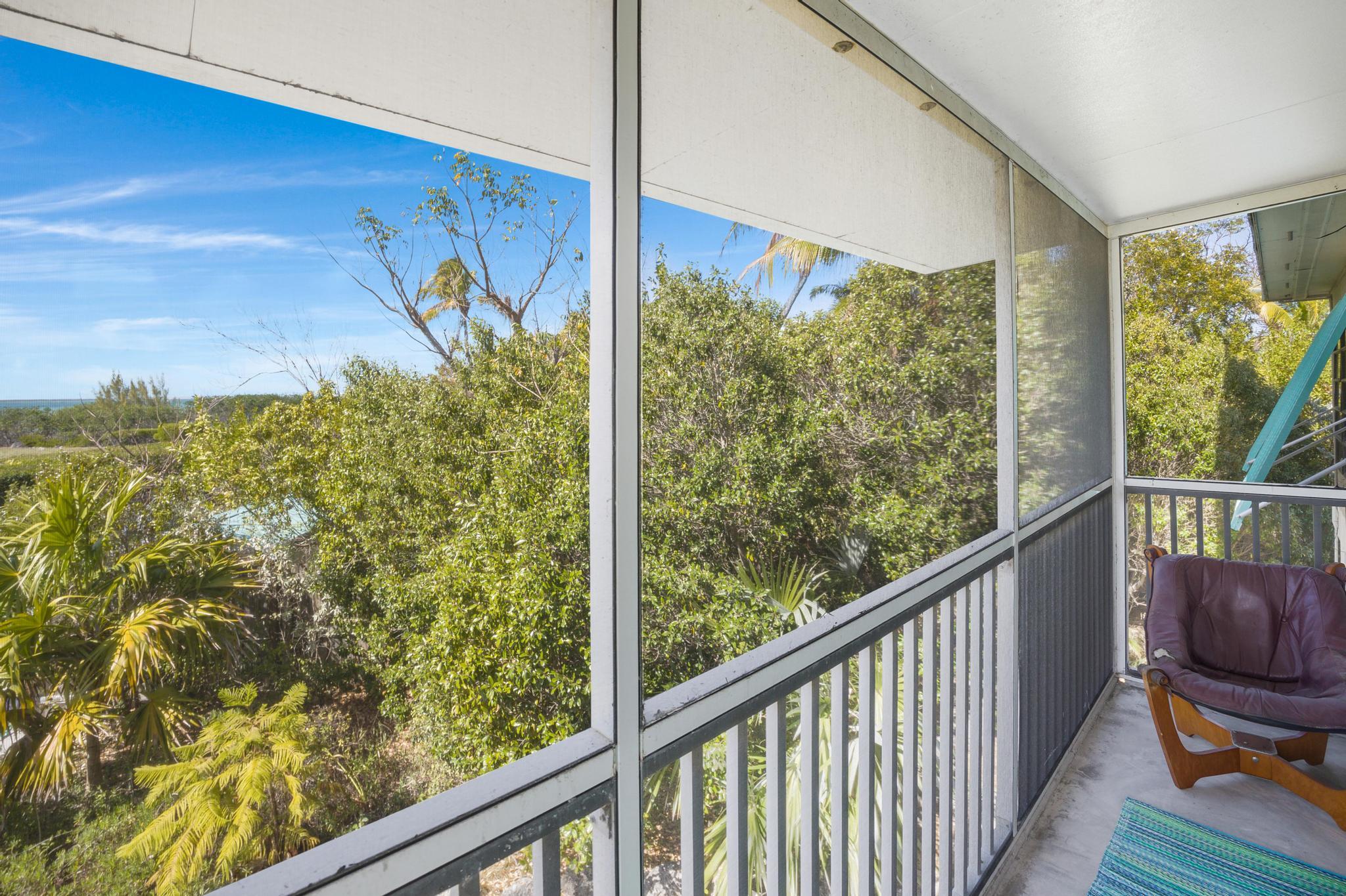 2148 Bahia Shores Road Big Pine Key, FL 33043 - Photo 7 of 35 a view of a balcony with chair and wooden floor