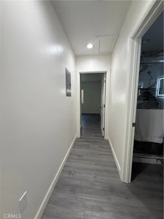 a bedroom with a bed and a flat tv screen on wall