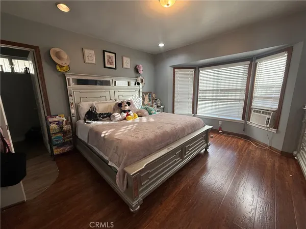 a bedroom with furniture and a flat screen tv