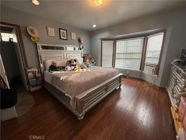 a kitchen with stainless steel appliances granite countertop a stove top oven a sink dishwasher and cabinets with wooden floor