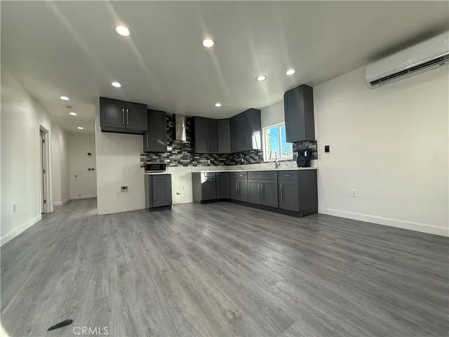 a large kitchen with stainless steel appliances granite countertop a large center island and a stove