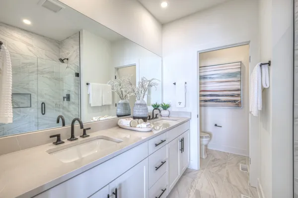 a bathroom with a double vanity sink mirror and double