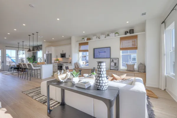 a living room with kitchen island furniture and a wooden floor