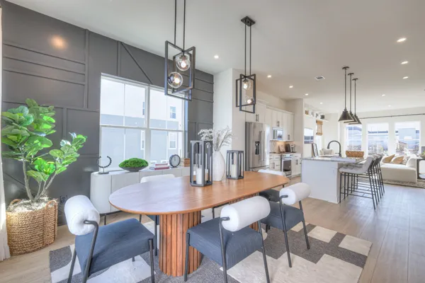 a dining room with furniture a chandelier and wooden floor