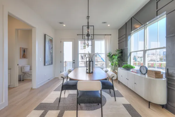 a view of a dining room with furniture window and wooden floor