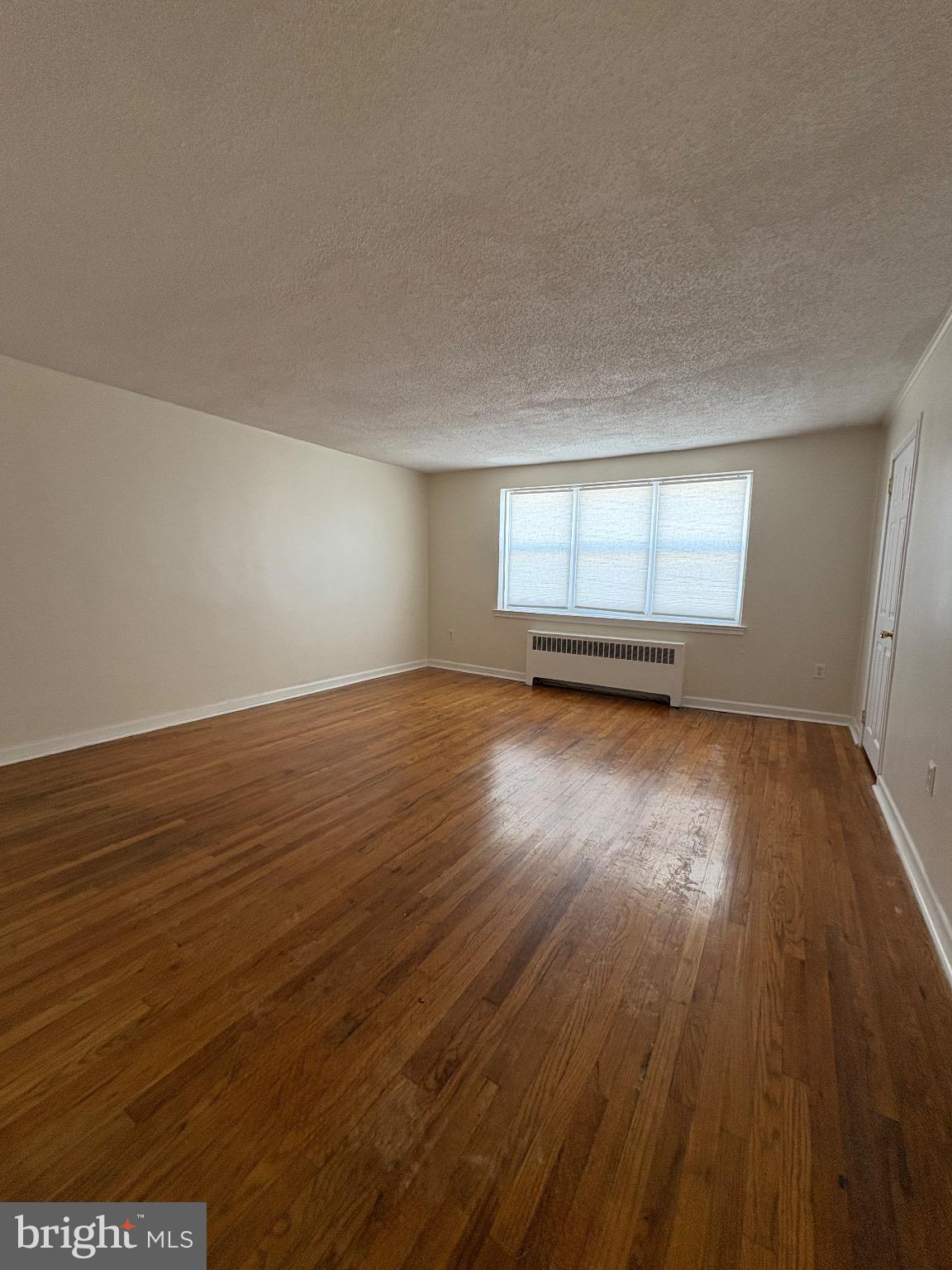 830 Emerson Street, Unit 2 Philadelphia, PA 19111 - Photo 4 of 10 Spacious living room with natural light & warmth.