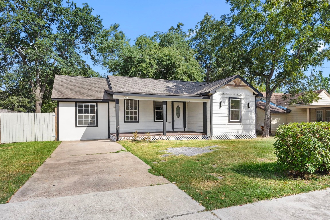905 Elm Avenue Pasadena, TX 77506 - Photo 2 of 21 a front view of a house with a garden and trees