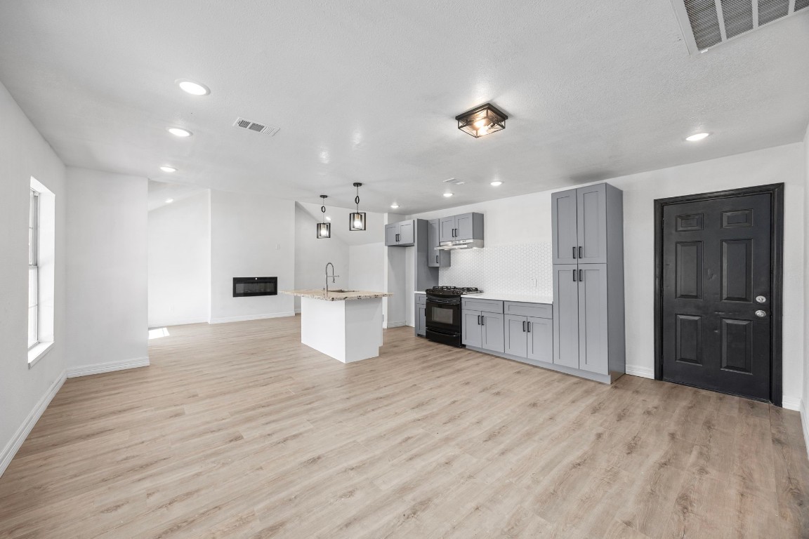 905 Elm Avenue Pasadena, TX 77506 - Photo 6 of 21 a view of kitchen with refrigerator stove and wooden cabinets