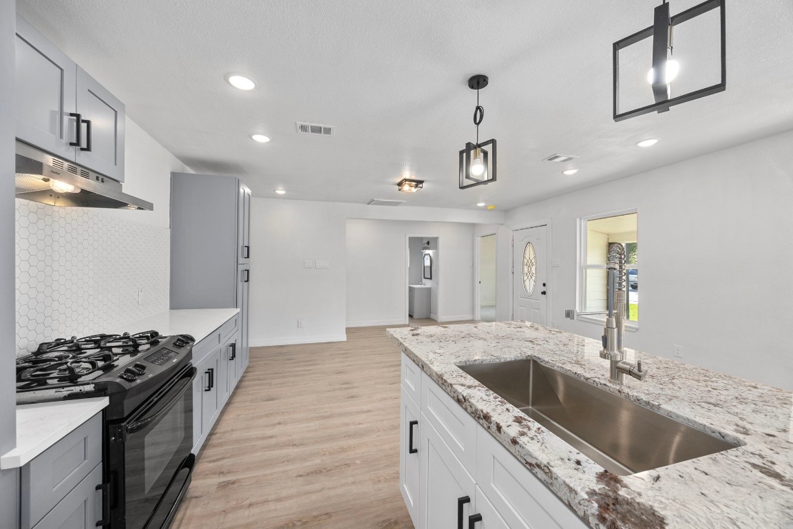 905 Elm Avenue Pasadena, TX 77506 - Photo 10 of 21 a kitchen with a sink stove and refrigerator
