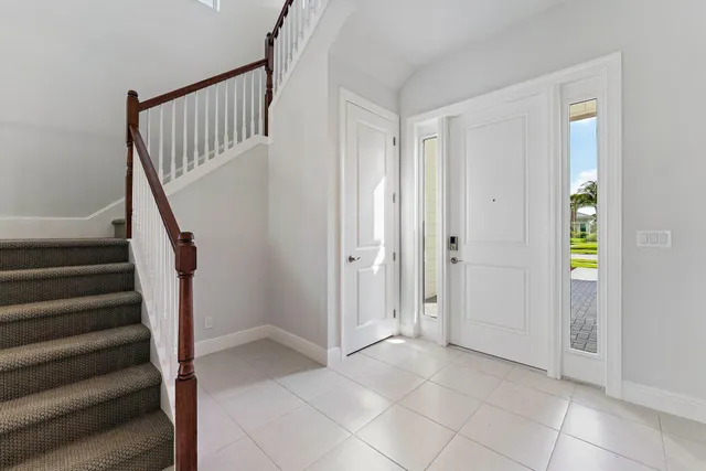 a kitchen with stainless steel appliances a sink a stove a refrigerator cabinets and a window