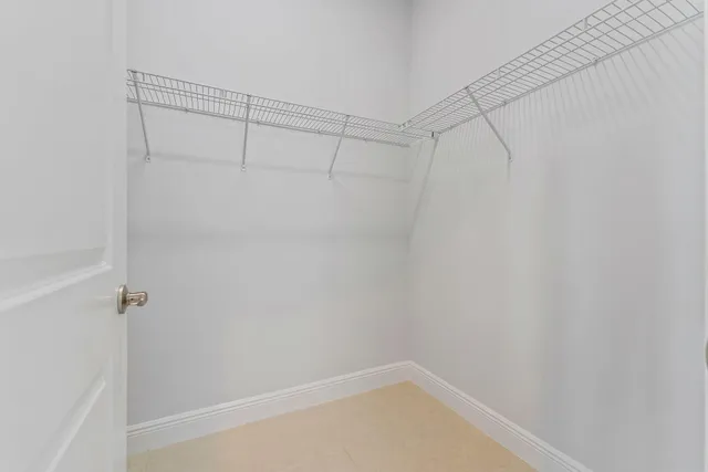 a spacious bathroom with a granite countertop sink a mirror and a bathtub