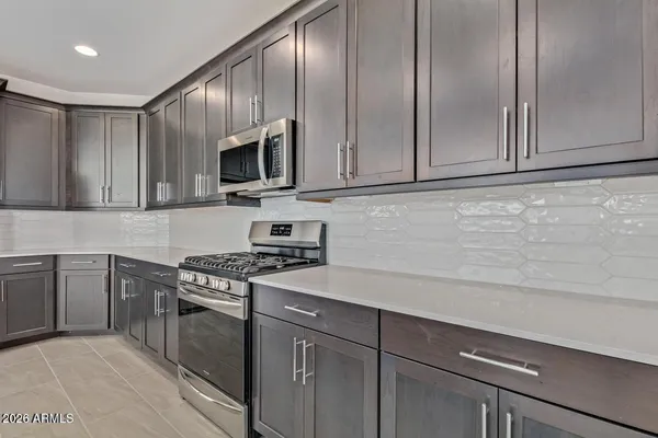 a kitchen with granite countertop cabinets stainless steel appliances and a sink