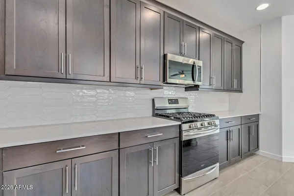 a kitchen with granite countertop cabinets stainless steel appliances and wooden floor