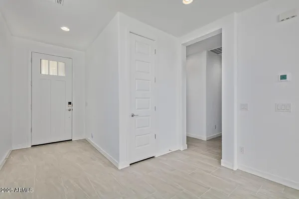 a view of an empty room with windows and closet