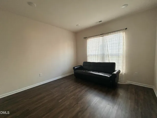a room with wooden floor and a window