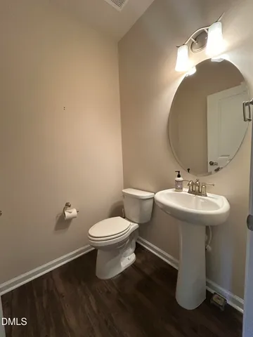 a bathroom with a sink toilet and a mirror