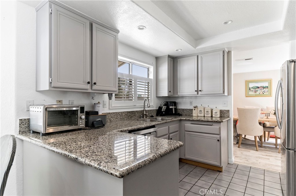 1491 Hunters Trail Glendora, CA 91740 - Photo 11 of 54 a kitchen with stainless steel appliances granite countertop a sink stove and cabinets