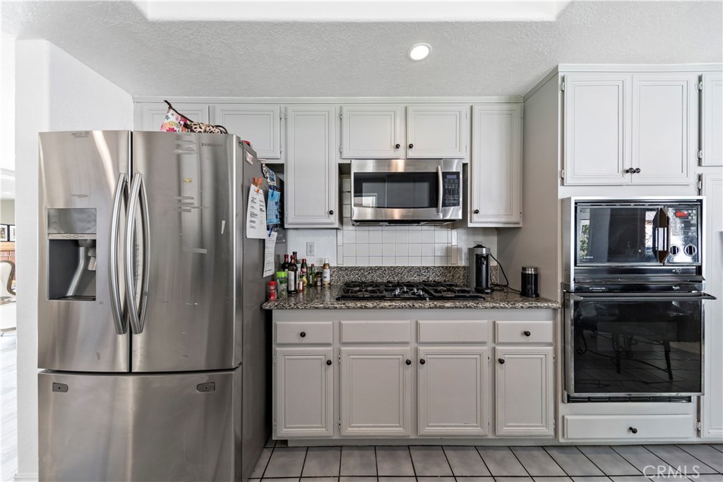 1491 Hunters Trail Glendora, CA 91740 - Photo 12 of 54 a kitchen with stainless steel appliances granite countertop a refrigerator stove a sink and dishwasher