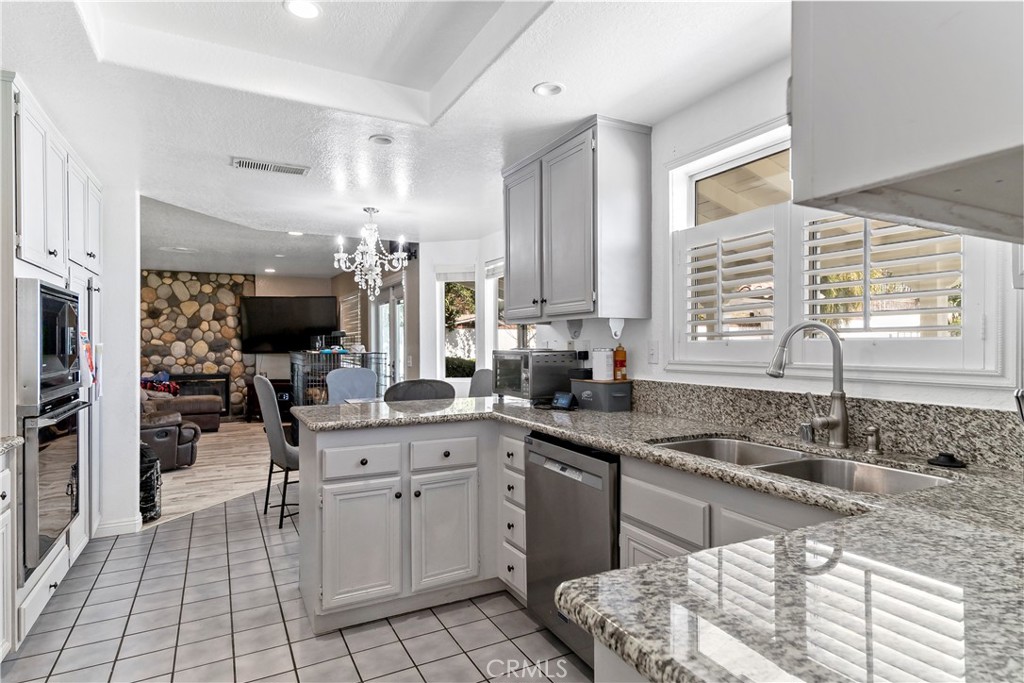 1491 Hunters Trail Glendora, CA 91740 - Photo 14 of 54 a kitchen with a sink stove and cabinets