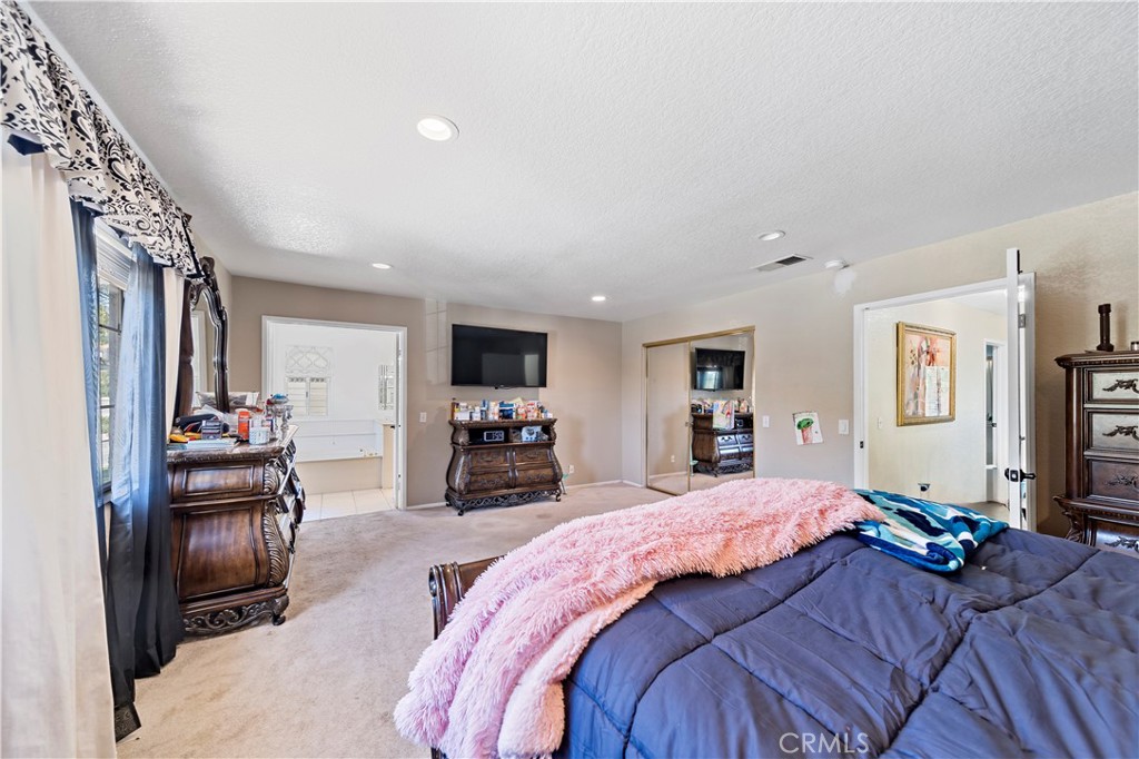 1491 Hunters Trail Glendora, CA 91740 - Photo 19 of 54 a bedroom with a bed couch and a flat tv screen