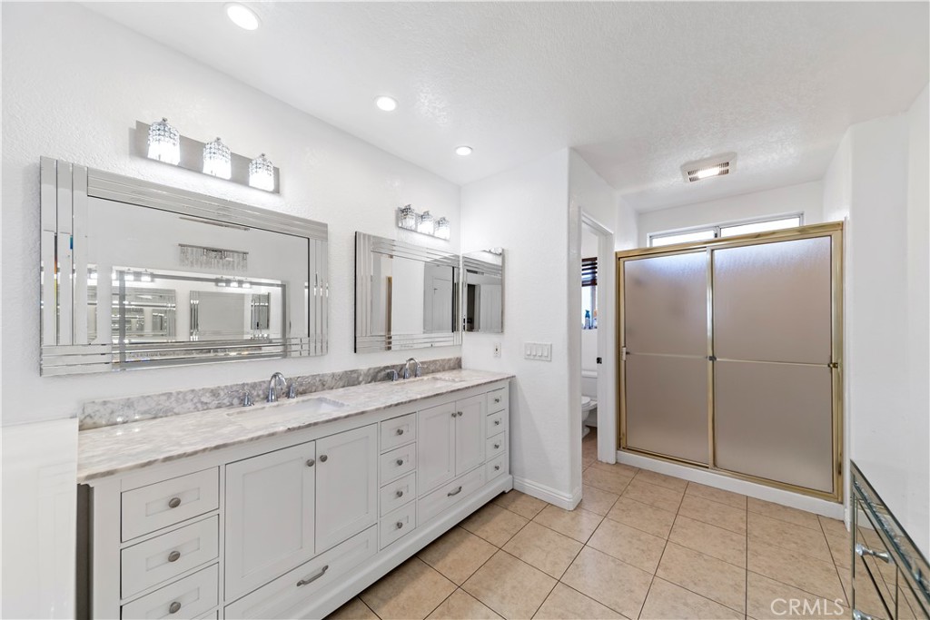 1491 Hunters Trail Glendora, CA 91740 - Photo 20 of 54 a spacious bathroom with a granite countertop sink mirror and cabinets