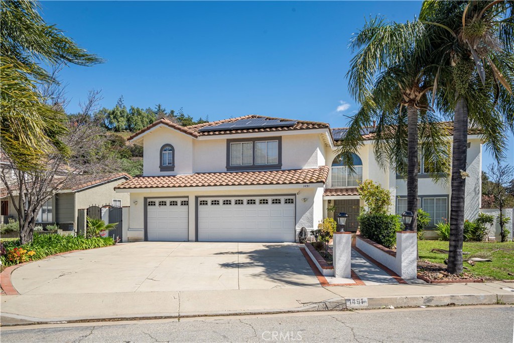 1491 Hunters Trail Glendora, CA 91740 - Photo 2 of 54 a front view of a house with a yard and garage
