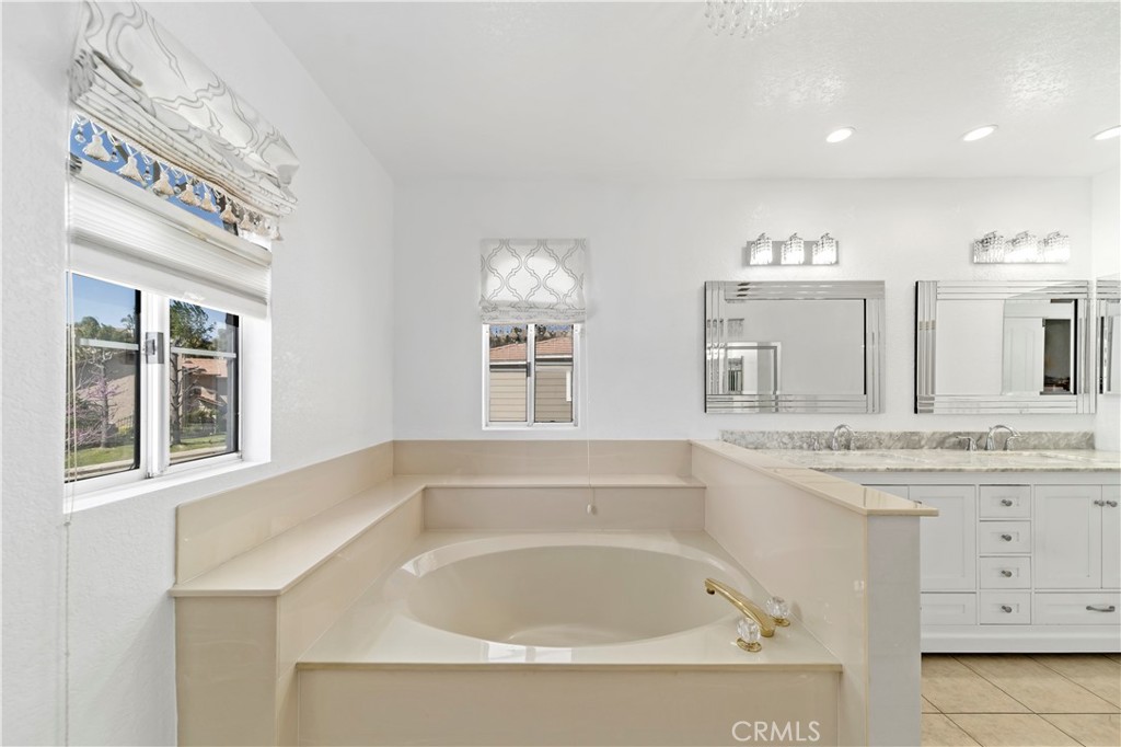 1491 Hunters Trail Glendora, CA 91740 - Photo 22 of 54 a bathroom with a tub sink and mirror