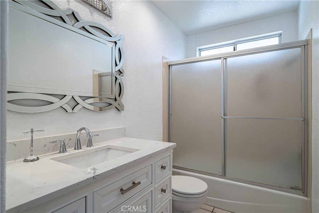 1491 Hunters Trail Glendora, CA 91740 - Photo 31 of 54 a bathroom with a granite countertop sink toilet and shower