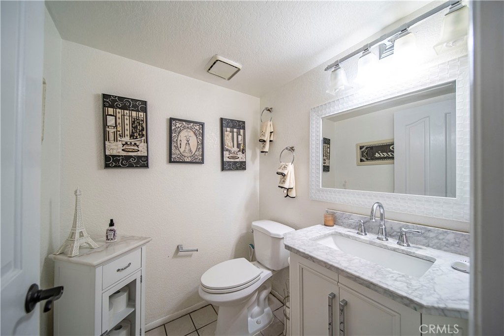 1491 Hunters Trail Glendora, CA 91740 - Photo 33 of 54 a bathroom with a granite countertop toilet sink and mirror