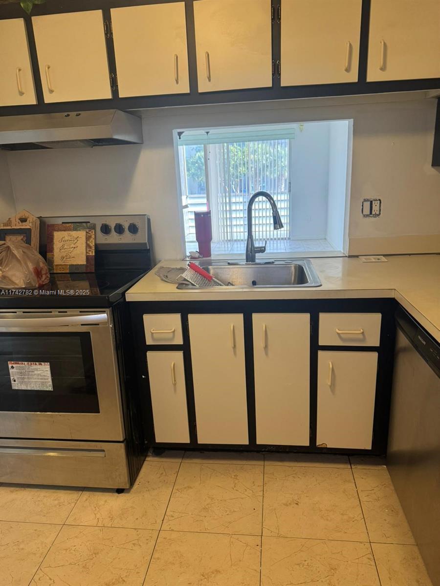 Lauderhill Lauderhill, FL 33313 - Photo 3 of 14 a kitchen with a stove and a sink