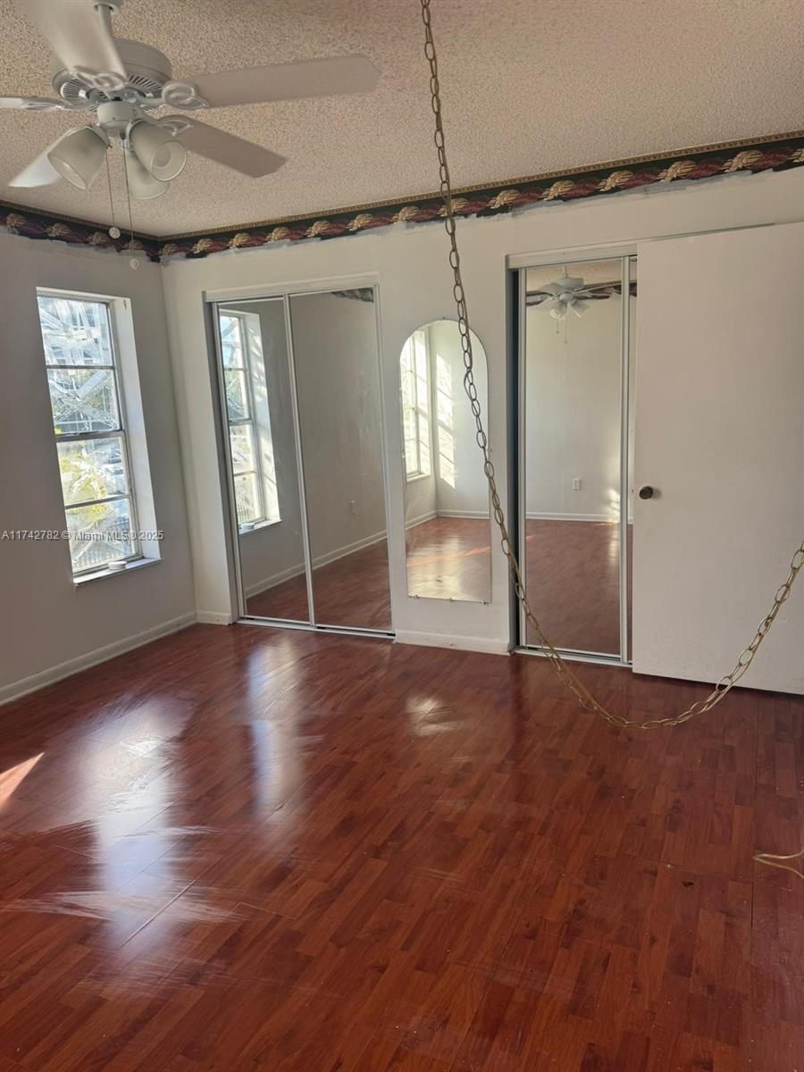 Lauderhill Lauderhill, FL 33313 - Photo 7 of 14 an empty room with wooden floor and windows