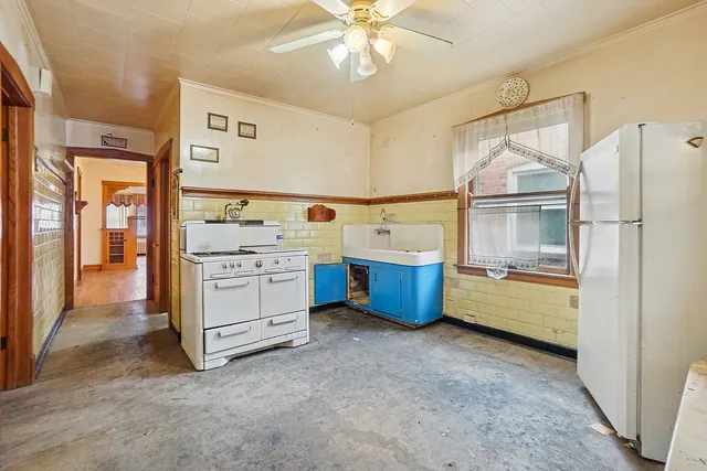 a view of a kitchen with refrigerator and cabinets