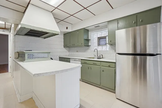 a kitchen with a sink a refrigerator and a stove