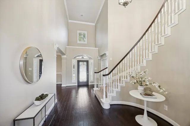 a bedroom with a bed couch and a large window