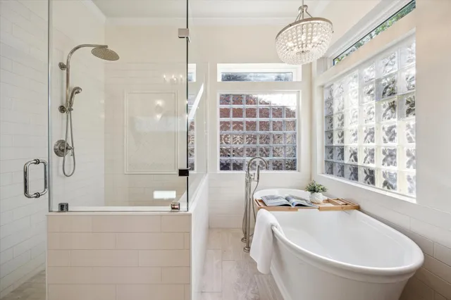 a large bathroom with a granite countertop tub a sink and a large mirror