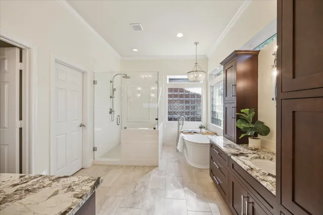 a spacious bathroom with a double vanity sink mirror double and shower
