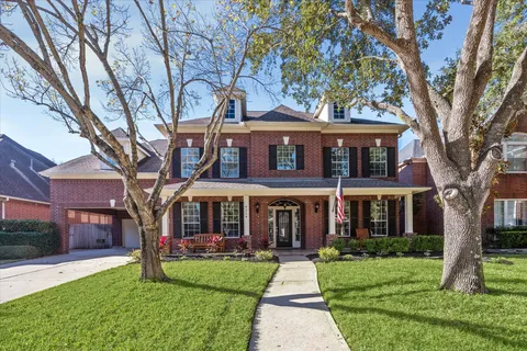 a spacious bathroom with a granite countertop sink mirror and bathtub
