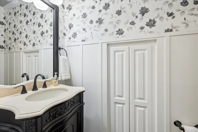 a bathroom with a granite countertop sink a toilet and shower