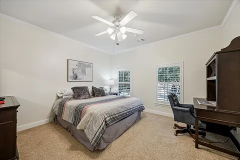 a bedroom with a large bed and a chandelier