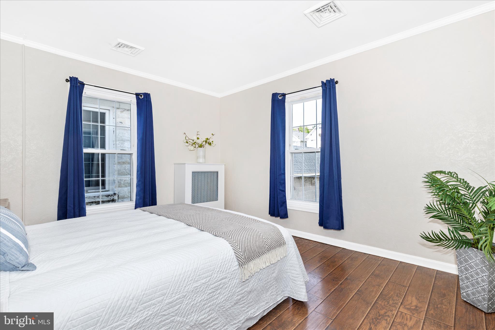 517 West Potomac Street Brunswick, MD 21716 - Photo 15 of 36 a bedroom with a bed and a potted plant