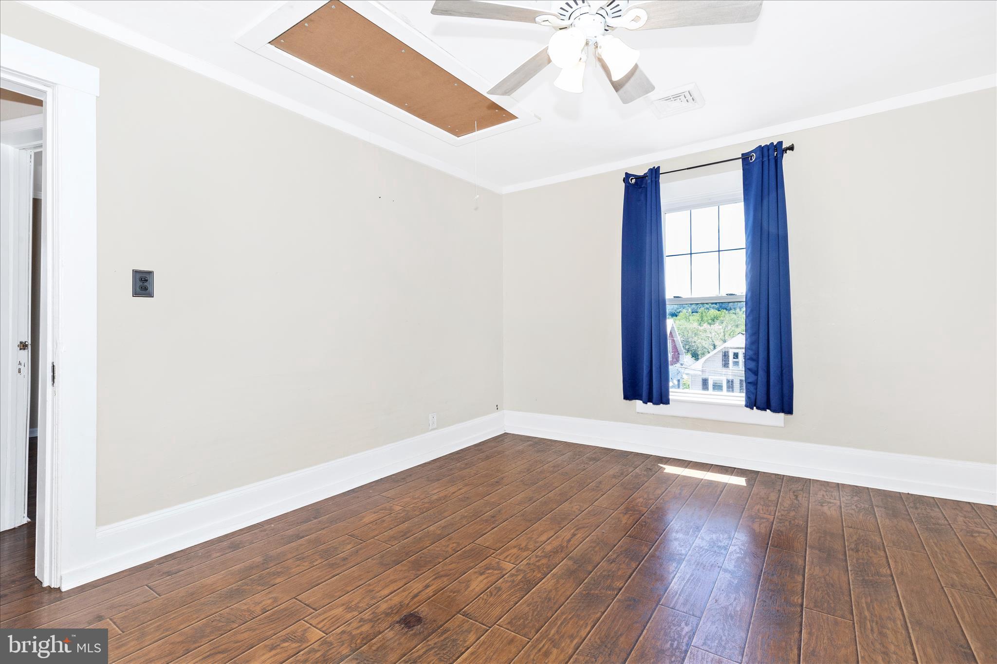 517 West Potomac Street Brunswick, MD 21716 - Photo 21 of 36 an empty room with wooden floor and windows