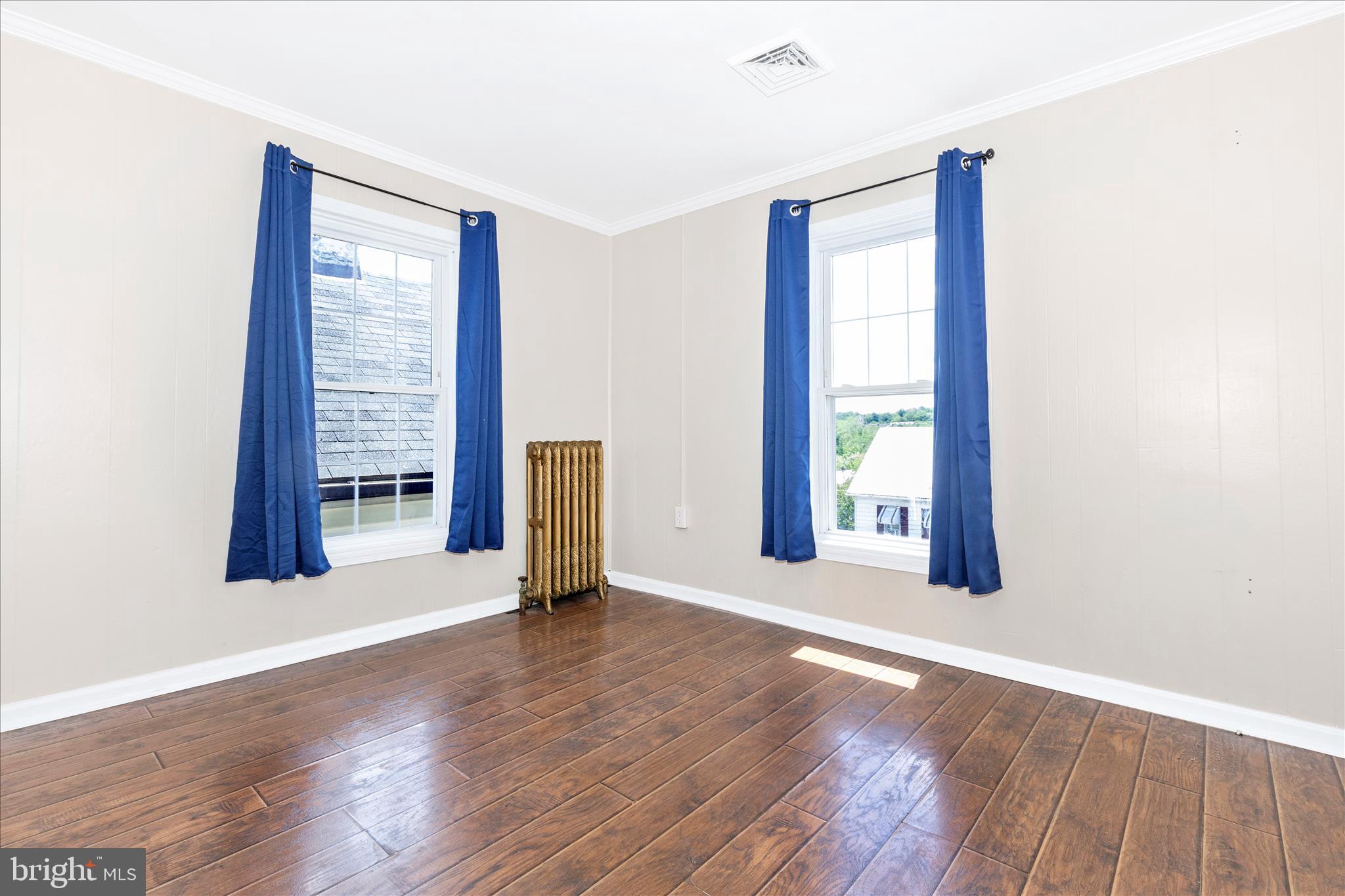 517 West Potomac Street Brunswick, MD 21716 - Photo 24 of 36 an empty room with wooden floor and windows