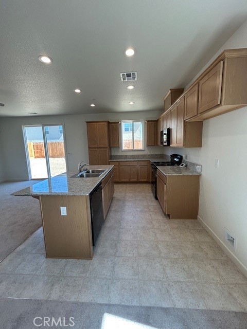 4705 Irma Drive Merced, CA 95348 - Photo 4 of 8 a large kitchen with stainless steel appliances a large counter top