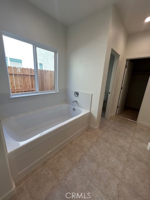 4705 Irma Drive Merced, CA 95348 - Photo 5 of 8 a spacious bathroom with a bathtub and a window