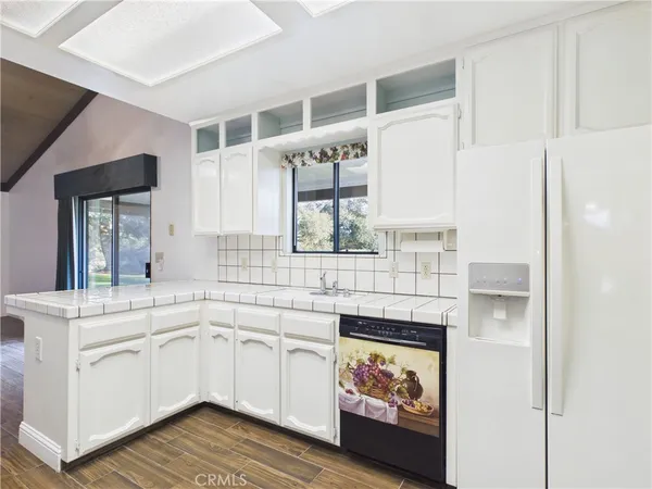 a kitchen with stainless steel appliances kitchen island granite countertop a sink and cabinets