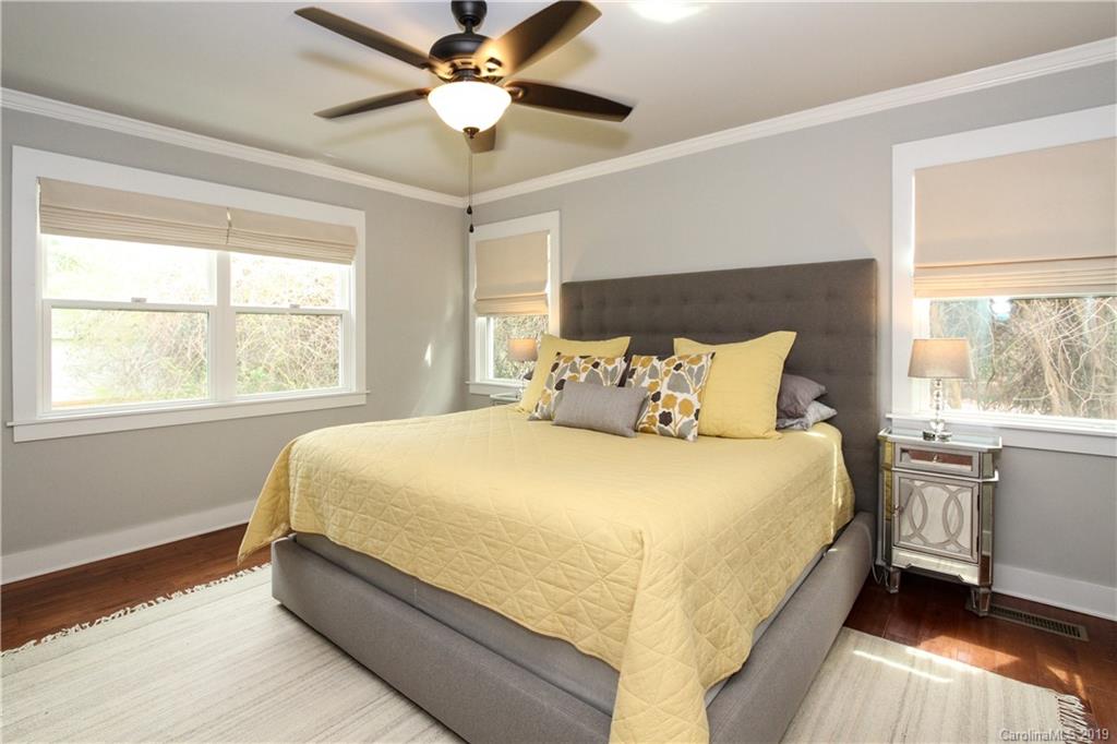 4217 Walker Road Charlotte, NC 28211 - Photo 13 of 34 a bed sitting in a bedroom next to a window