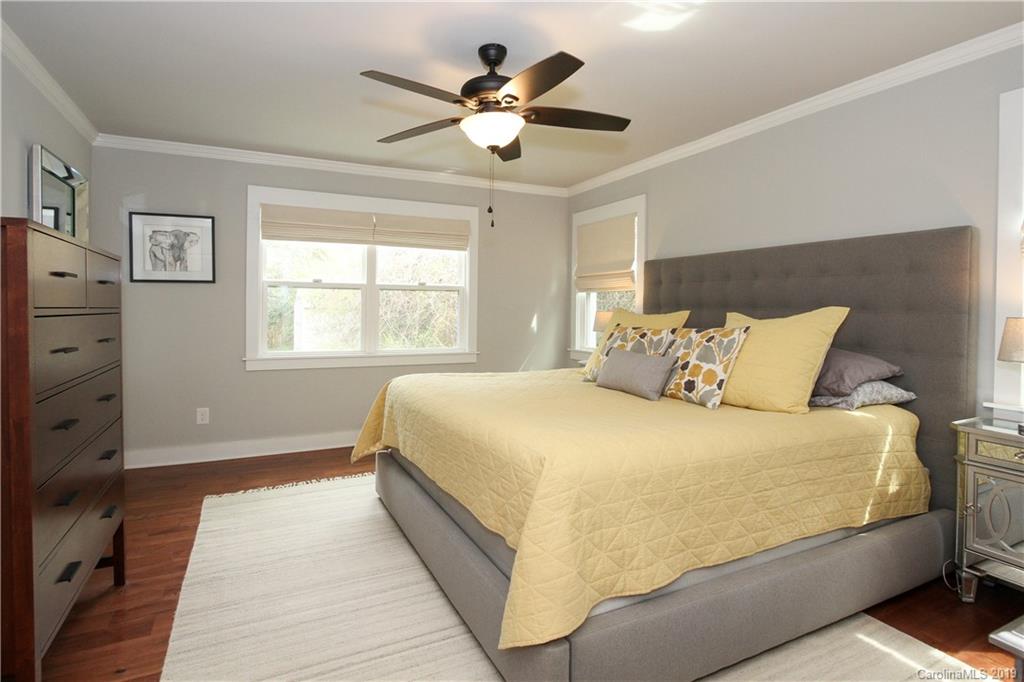 4217 Walker Road Charlotte, NC 28211 - Photo 15 of 34 a bedroom with a bed and a ceiling fan