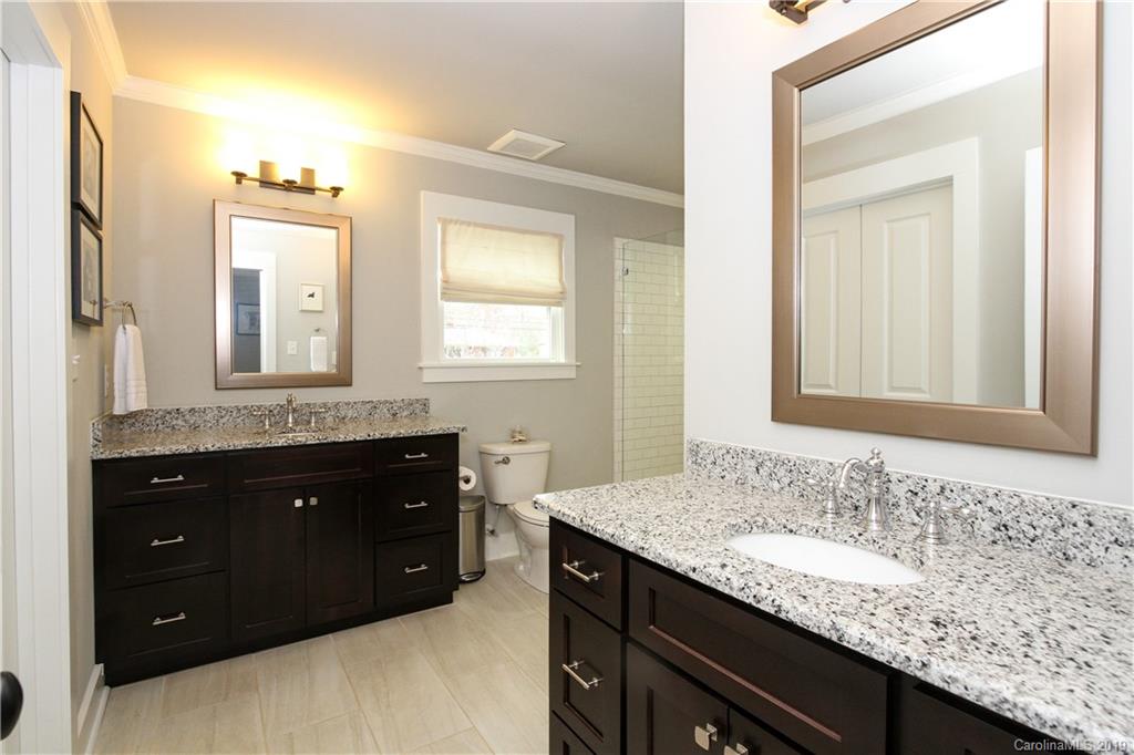 4217 Walker Road Charlotte, NC 28211 - Photo 16 of 34 a bathroom with a granite countertop sink and a mirror