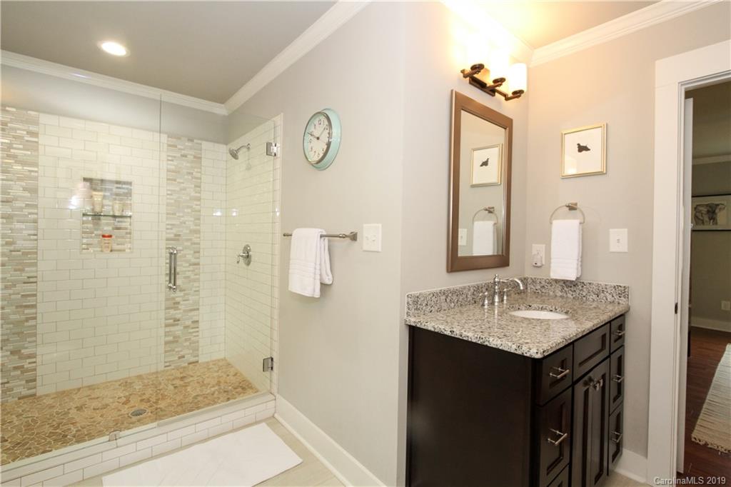 4217 Walker Road Charlotte, NC 28211 - Photo 18 of 34 a bathroom with a granite countertop sink and a mirror