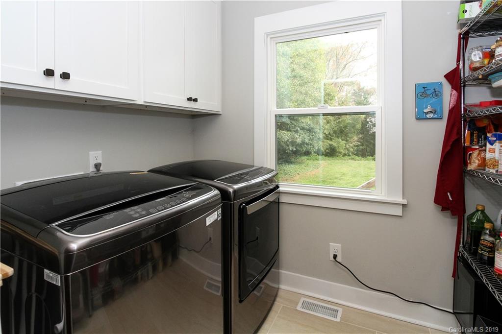 4217 Walker Road Charlotte, NC 28211 - Photo 22 of 34 a kitchen with a stove and a window